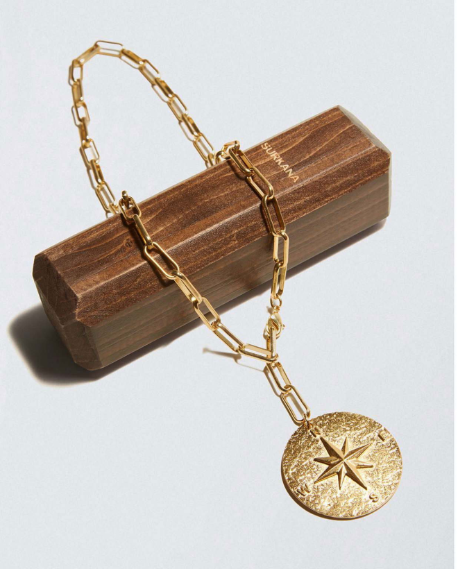 Golden medallion with compass rose Gold