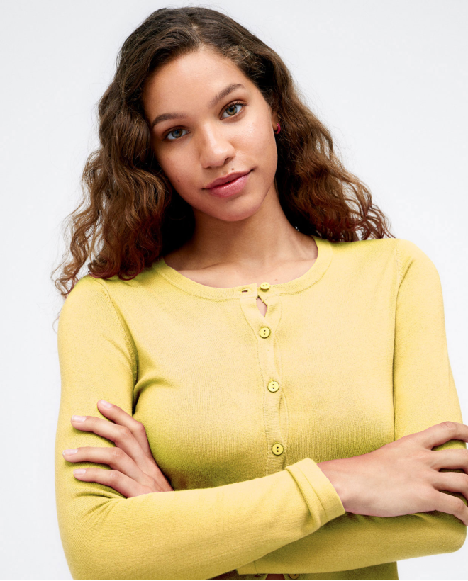 Short knitted cardigan with long sleeves. Plain. Yellow
