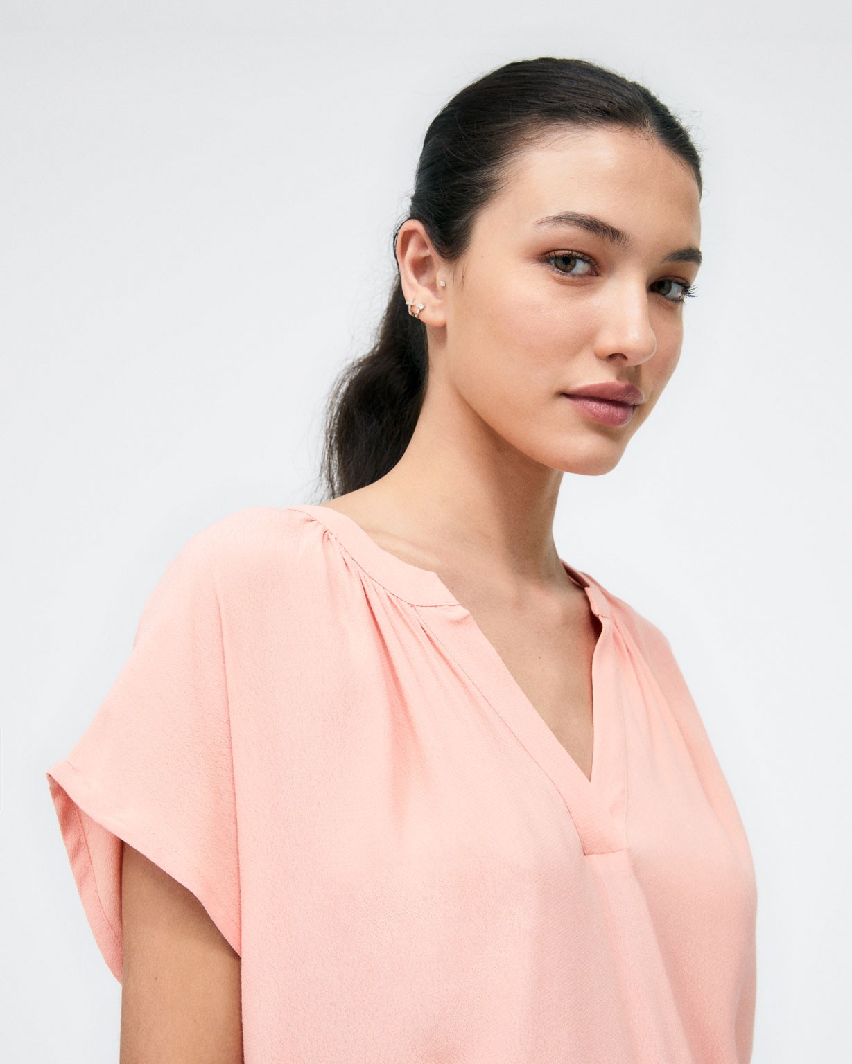 Short sleeve V-neck blouse.  Coral